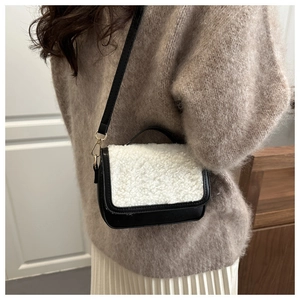 Mini crossbody bag featuring black leather and cream faux fur with gold hardware details