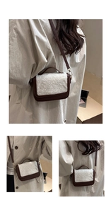 Detail of crossbody bag with brown leather, white faux fur flap, and gold hardware