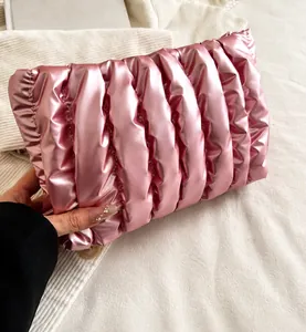 Close-up of a pink metallic quilted cloud bag featuring soft pleated textures