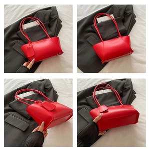 Vue détaillée du sac cabas rouge en similicuir montrant la forme trapèze et coutures