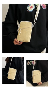Crossbody phone bag with yellow canvas, silver star patterns, and white strap details