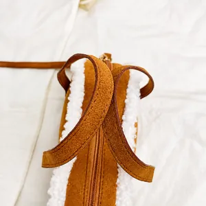 Detail showing comfortable dual handles and plush拼接 faux shearling texture on brown bag