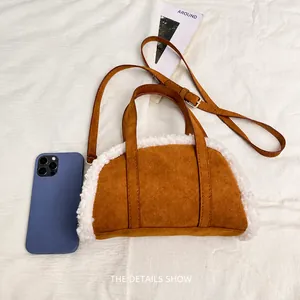 Mini brown suede shoulder bag with white faux fur trim shown next to a smartphone
