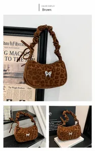Detail of coffee leopard print bag featuring silver butterfly buckle and pleated handle