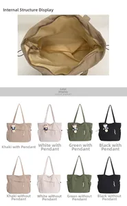 Detail view of corduroy tote bag interior and color selection with bear pendant