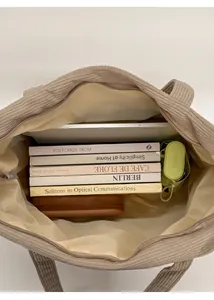 Interior view of beige corduroy tote bag showing large capacity for books and laptop