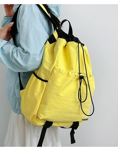 Lightweight yellow waterproof nylon drawstring backpack with black adjustable straps