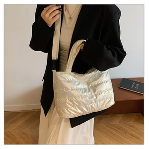 Détail du sac fourre-tout matelassé argenté avec bandoulière réglable crème et large