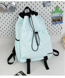 Detail of light blue drawstring backpack showing waterproof nylon and VOKOKO logo