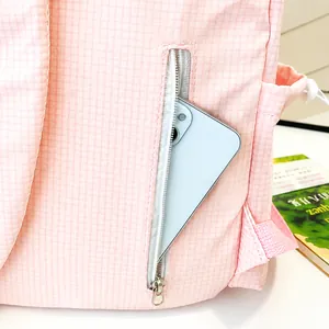Close-up of a pink backpack featuring a secure hidden back zipper pocket for smartphones