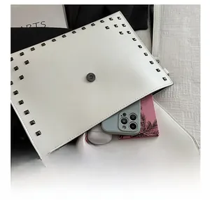 Internal storage capacity of white envelope bag with stylish dark stud trim details