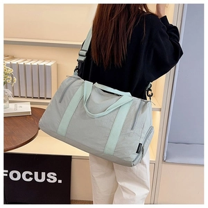 Light green nylon gym bag featuring adjustable shoulder strap and large capacity