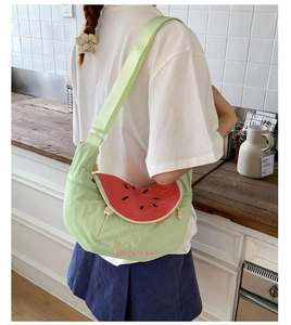 Detail of cute watermelon crossbody bag with green strap and fruit slice embroidery