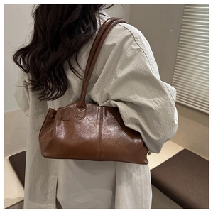 Brown vintage wax leather tote bag shown on model for stylish shoulder carrying