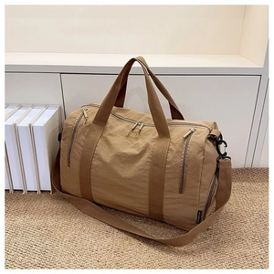 Detail view of khaki nylon travel bag with LANWUDI embroidery and zip pockets