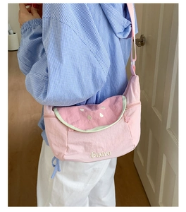 Pink watermelon crossbody bag detail showing guava embroidery and adjustable fabric strap