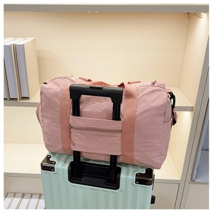 Pink nylon travel tote detail with trolley sleeve and secure hidden zipper pocket