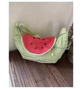 Detail of mint green crossbody bag with watermelon slice embroidery and adjustable strap