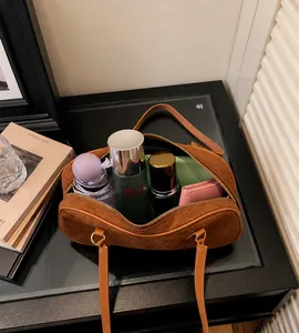 Detailed interior of large brown suede shoulder bag showing spacious storage capacity