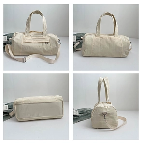 Detailed views of creamy white nylon duffel bag with shoulder strap and metal hardware
