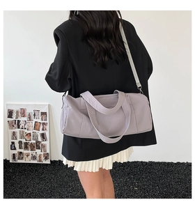 Detailed view of lavender nylon fitness bag worn as crossbody with adjustable strap