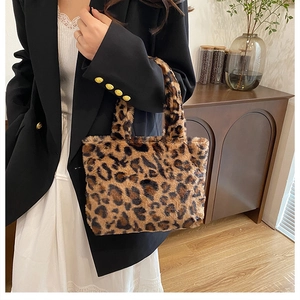 Chic leopard print faux fur tote bag shown held by model in a stylish indoor setting