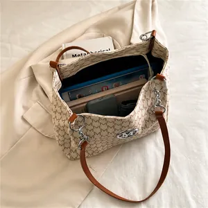 Interior view showing the large capacity of the beige patterned tote bag with daily items