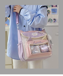 Detailed view of pink and purple nylon crossbody bag with cat ears and PVC window