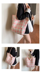 Detail of pink and green plaid tote bag showing large capacity and textured fabric
