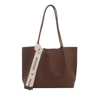 Minimalist large brown leather tote bag with vertical stitching and fashion strap