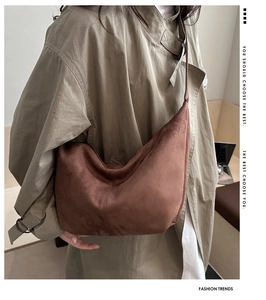 Close-up of brown faux suede hobo bag showing soft matte texture and natural drape