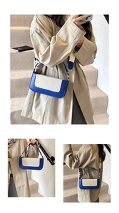 Detail of blue and white patchwork baguette bag shown with adjustable leather straps