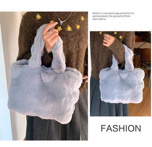 Detail of light blue faux fur tote bag with plush handles and soft cloud-like texture
