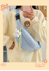 Close-up of light blue nylon chest bag with cloud plush and colorful beaded charms