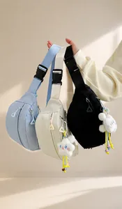 Detailed view of nylon chest bags in three colors with custom zipper and plush pendants