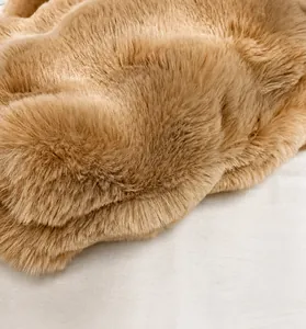 Detailed macro view of the premium plush faux fur texture and soft camel fibers
