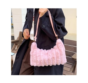 Detail of pink faux fur underarm bag with vertical pleated texture and rope strap
