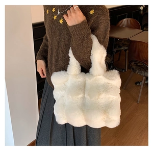 Detailed view of plush faux fur tote bag in white showing soft texture and handle