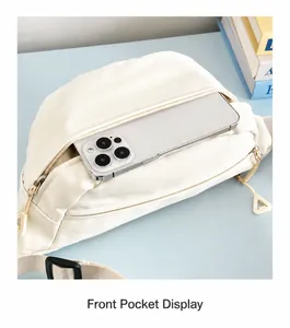 Detailed front zipper pocket of off-white chest bag holding a large smartphone