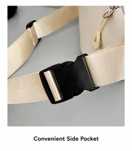 Detail of adjustable nylon strap and plastic buckle on cream crossbody chest bag