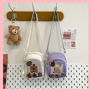 Detail of Japanese style Ita bags in cream and lavender with transparent display window