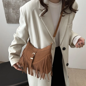 Brown fringe tote bag with metal buckle and adjustable strap in bohemian style