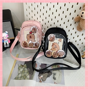 Detail view of pink and black crossbody bags with transparent DIY display pockets
