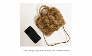 Size comparison of khaki faux fur plush bag with a smartphone and woven handle