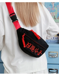 Detail der Umhängetasche mit roter Stickerei und sportlichem verstellbarem Gurt