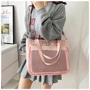 Detail of pink transparent ita bag with heart metal buckle and adjustable strap