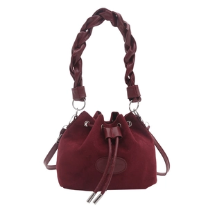 Vintage burgundy suede bucket bag with woven handle and drawstring closure