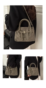 Macro detail of faux suede tote bag featuring fashion buckle and metallic hardware
