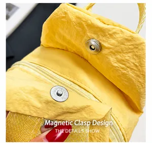 Détail d'un sac en nylon jaune avec fermeture magnétique sécurisée et zip fluide