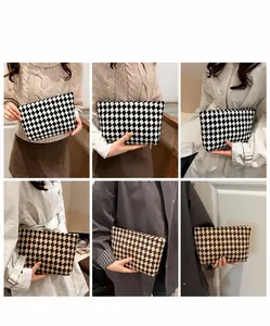 Lifestyle shots of women's long plaid wallet clutch with zipper and classic check pattern